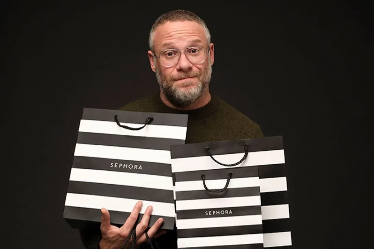Seth Rogen Sephora campaign photo, Rogen holding black and white sephora bag